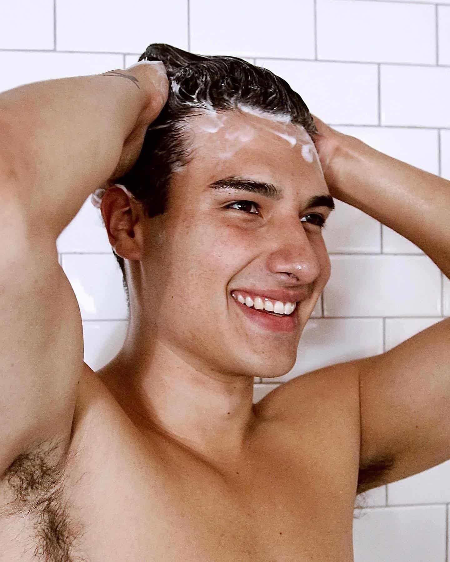 man shampooing hair