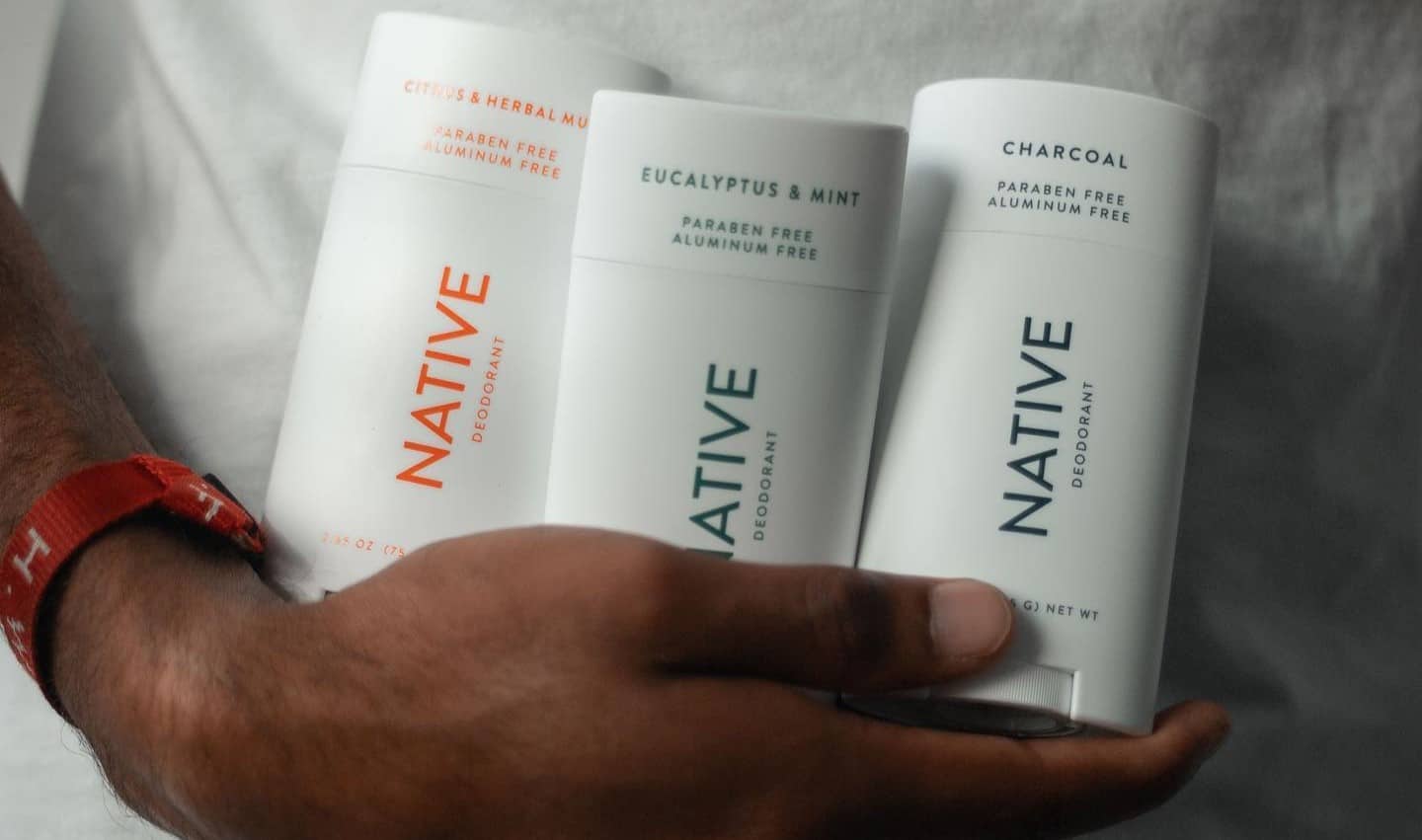 man carrying three different kinds of native deodorant sticks